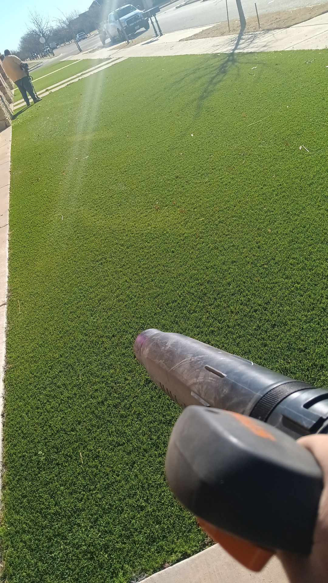 Clean cut lawn with blower in hand